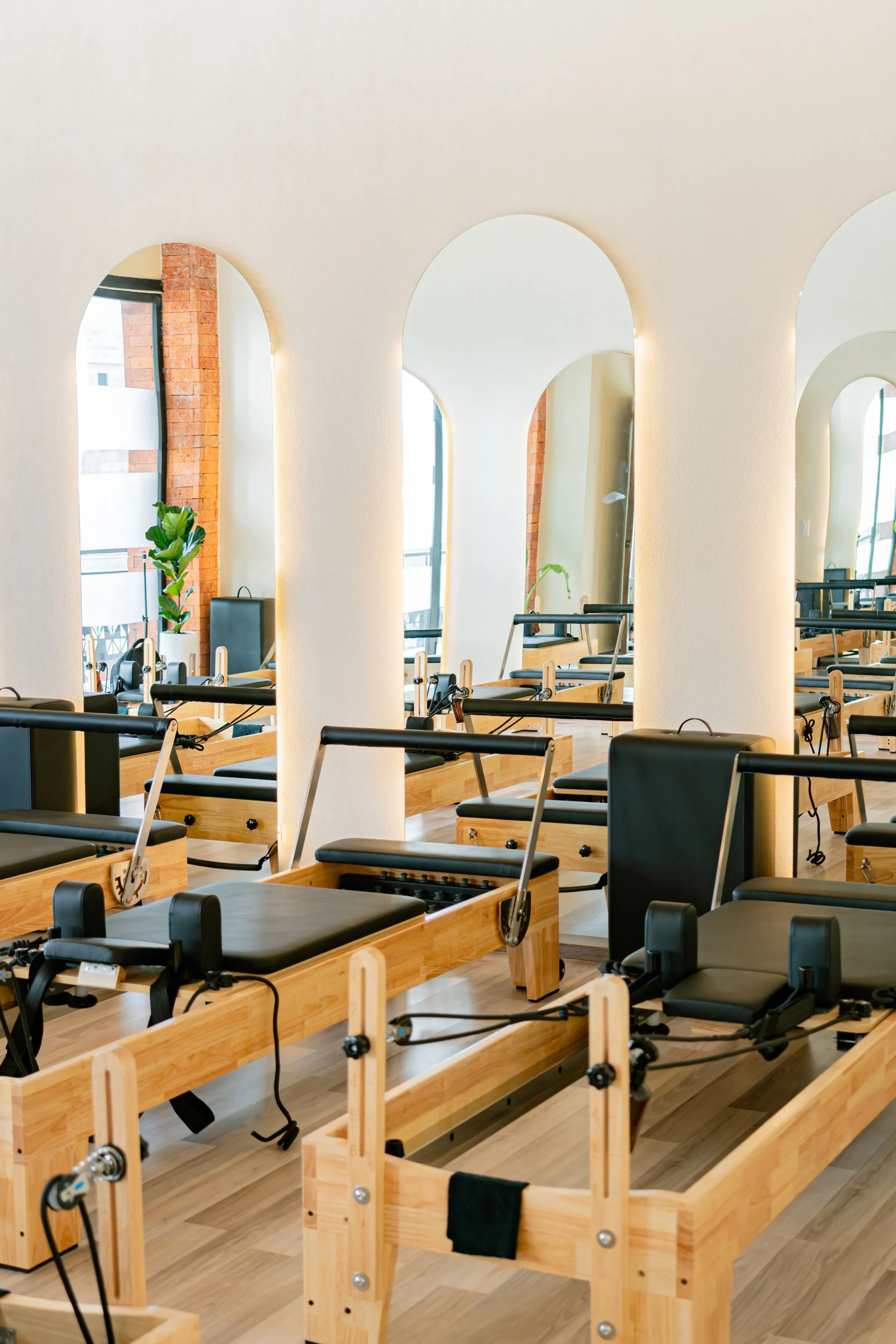 Arched, backlit mirrors above reformer beds